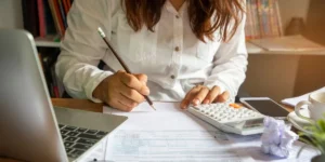 image of lady with pencil and tools while working at home office